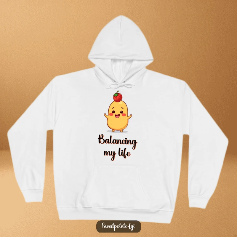 Funny hoodie depicting a grinning sweet potato character balancing a strawberry on its head, offering cozy comfort and a humorous challenge.