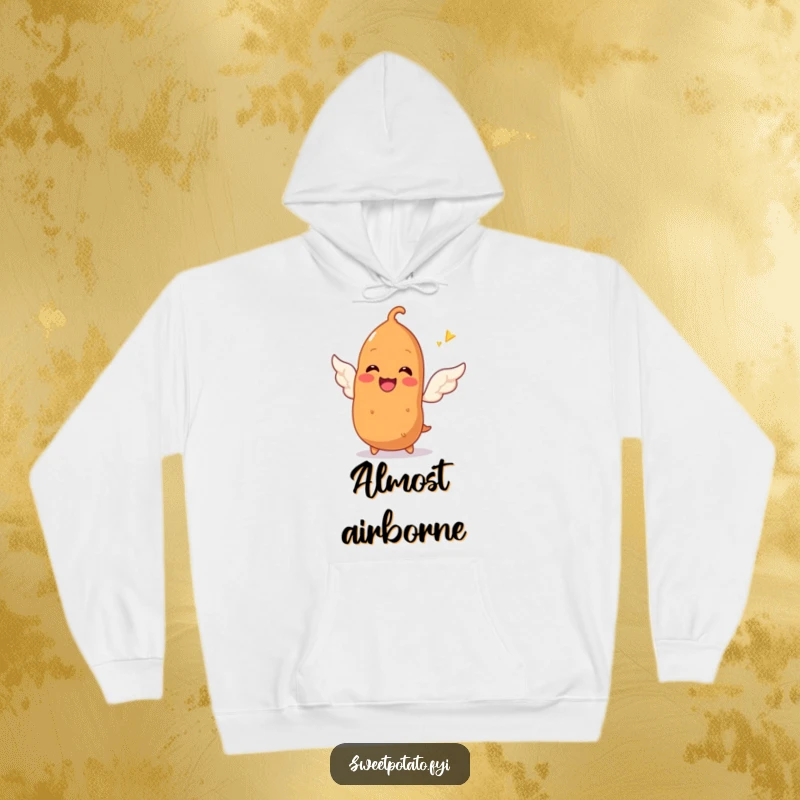 Funny hoodie with a smiling sweet potato character gleefully attempting to sprout tiny wings, offering comfort and a humorous dose of aspiration.