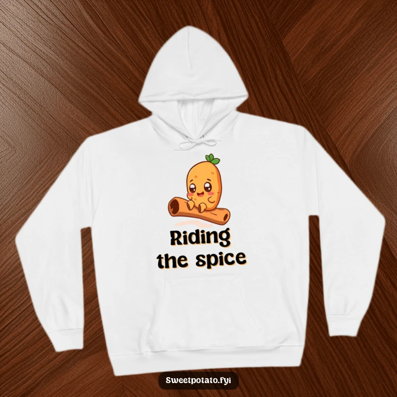 Funny hoodie depicting a wide-eyed sweet potato character joyfully sliding down a giant cinnamon stick, offering warmth and a hilarious adventure.